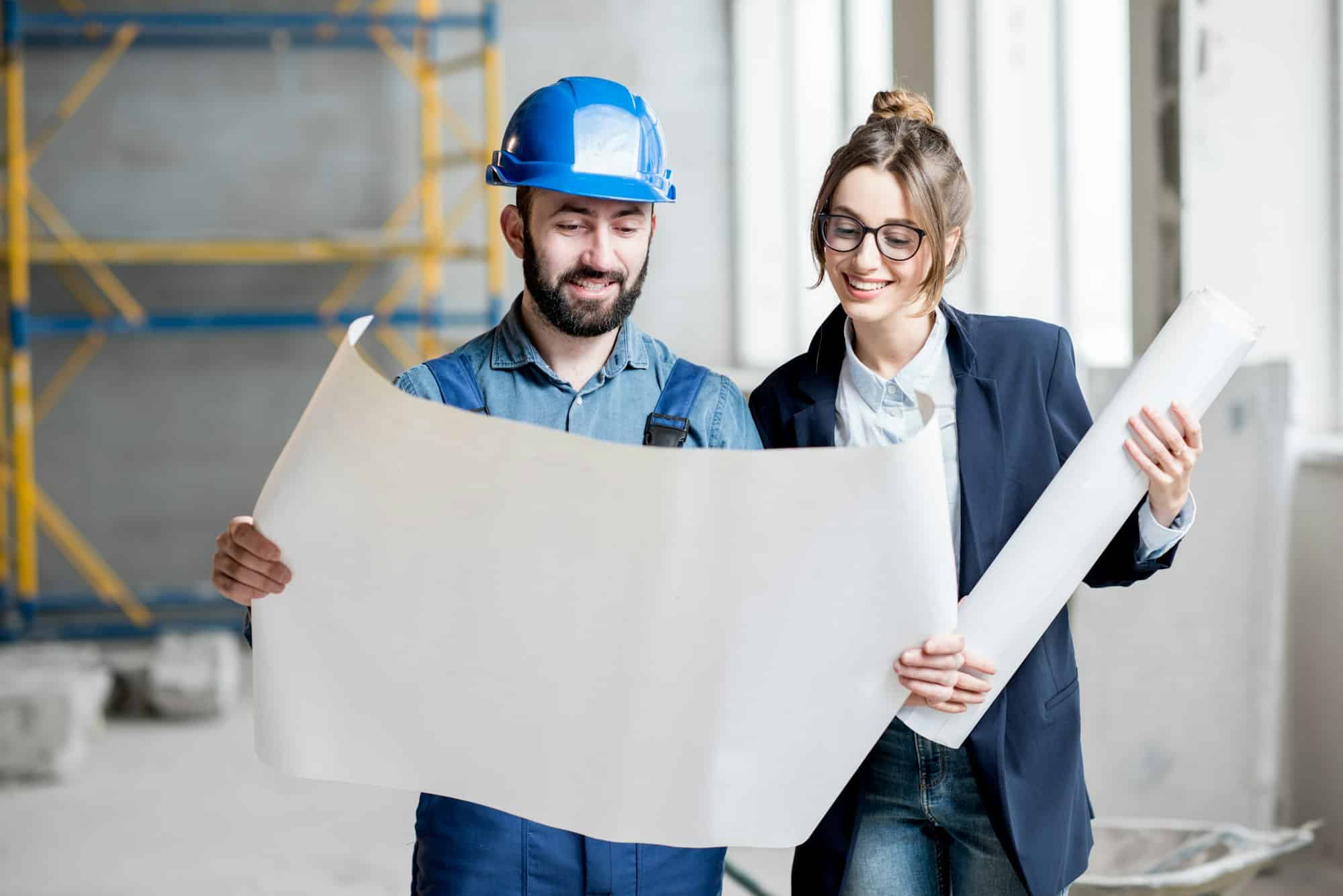 Builder with businesswoman at the construction site