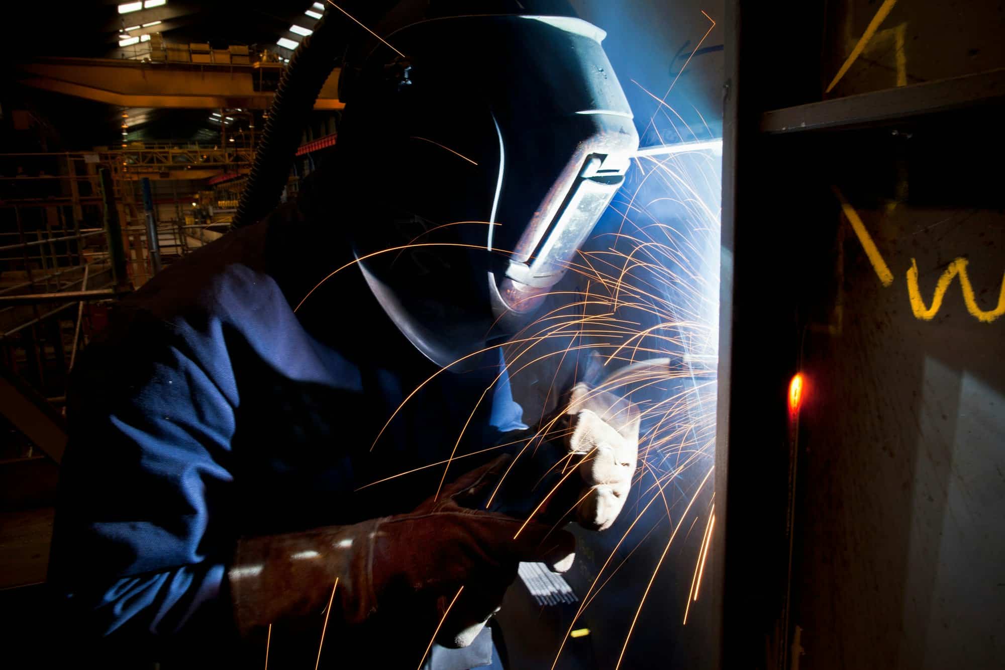 Welder at work in shipyard